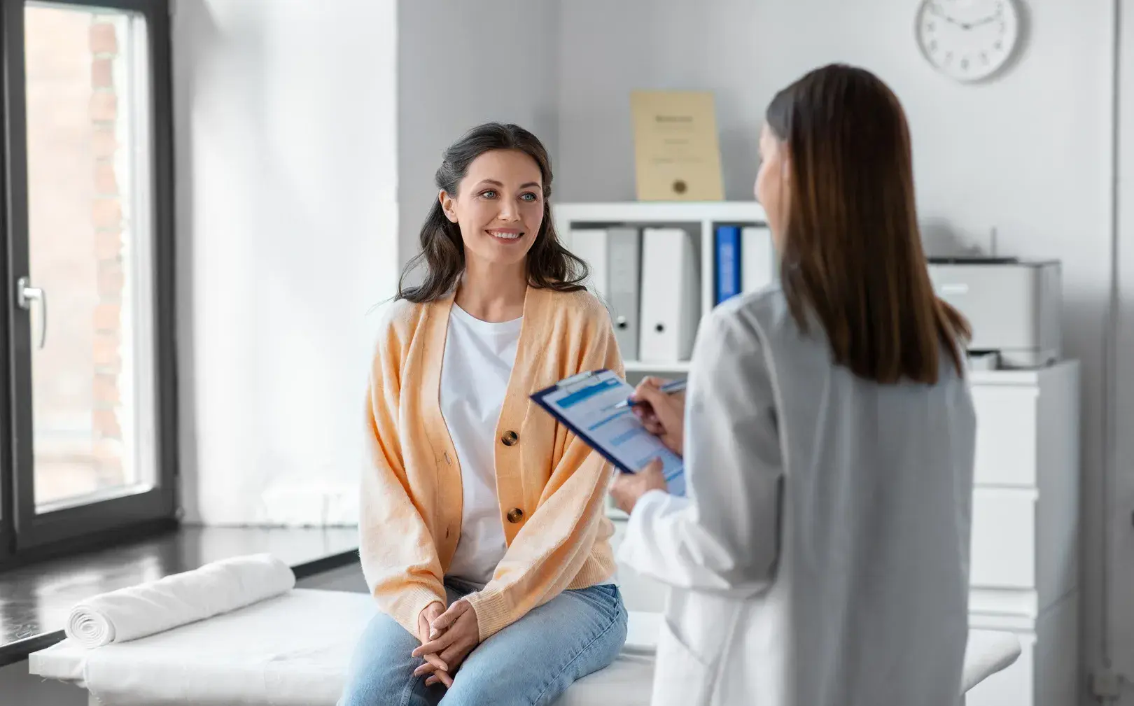 Clinician talking with a patient during a women's health consultation